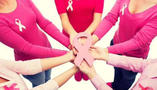 47678839 - healthcare, people and medicine concept - close up of women in blank shirts with pink breast cancer awareness ribbons over white background